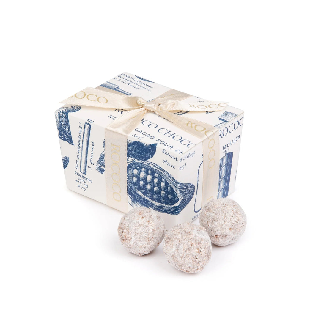 Two chocolates with a box labeled on a white background