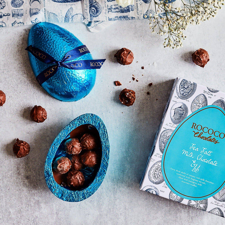 Delicious Rococo Sea Salt Milk Chocolates Egg | Hand foiled and decorated luxury Chocolate Egg | Milk Chocolate Easter Egg filled with ganache milk chocolate truffles | Light blue foiled and ribboned easter egg | Easter Egg for sharing | Rich and luxurious easter egg for family 